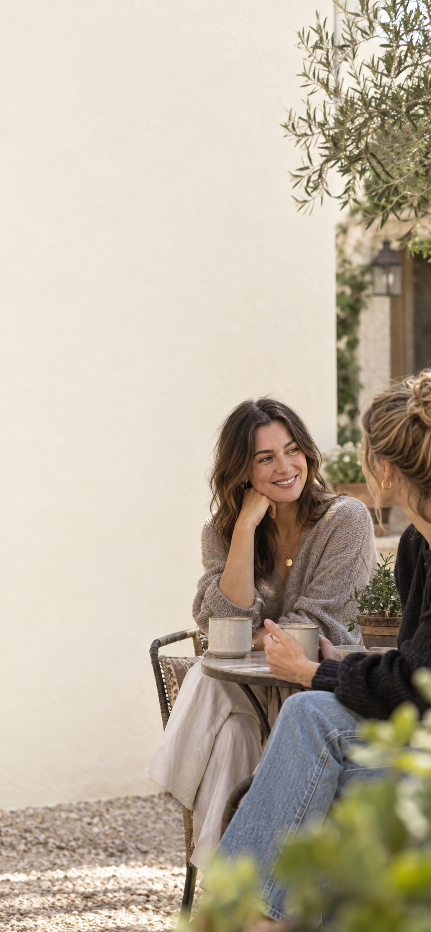 A woman sharing a moment with a friend outdoors.
